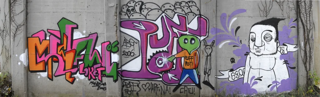 Muro con graffiti colorati e personaggi illustrati, realizzato a Cairate nel 2006.