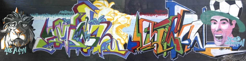 Grande murale con leoni, lettering e figure colorate, Tradate 2006.